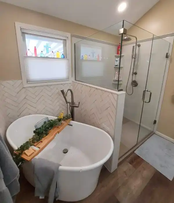 Bathroom with a freestanding tub beside a glass-enclosed shower