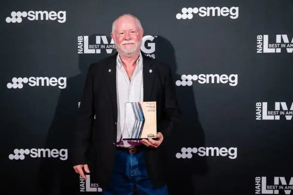 Mike Pressgrove, PDQ Construction owner, holding the BALA award for NAHB National Remodeler of the Year