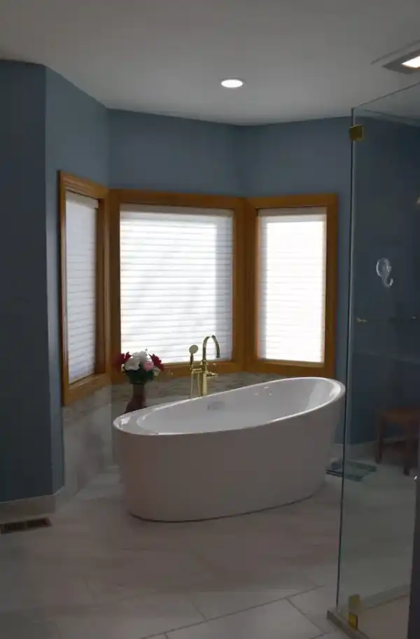 Freestanding tub against a blue painted wall