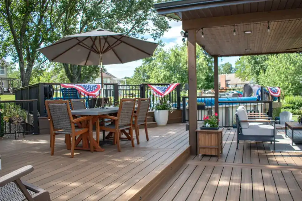 Composite deck with a dining set under a covered pergola